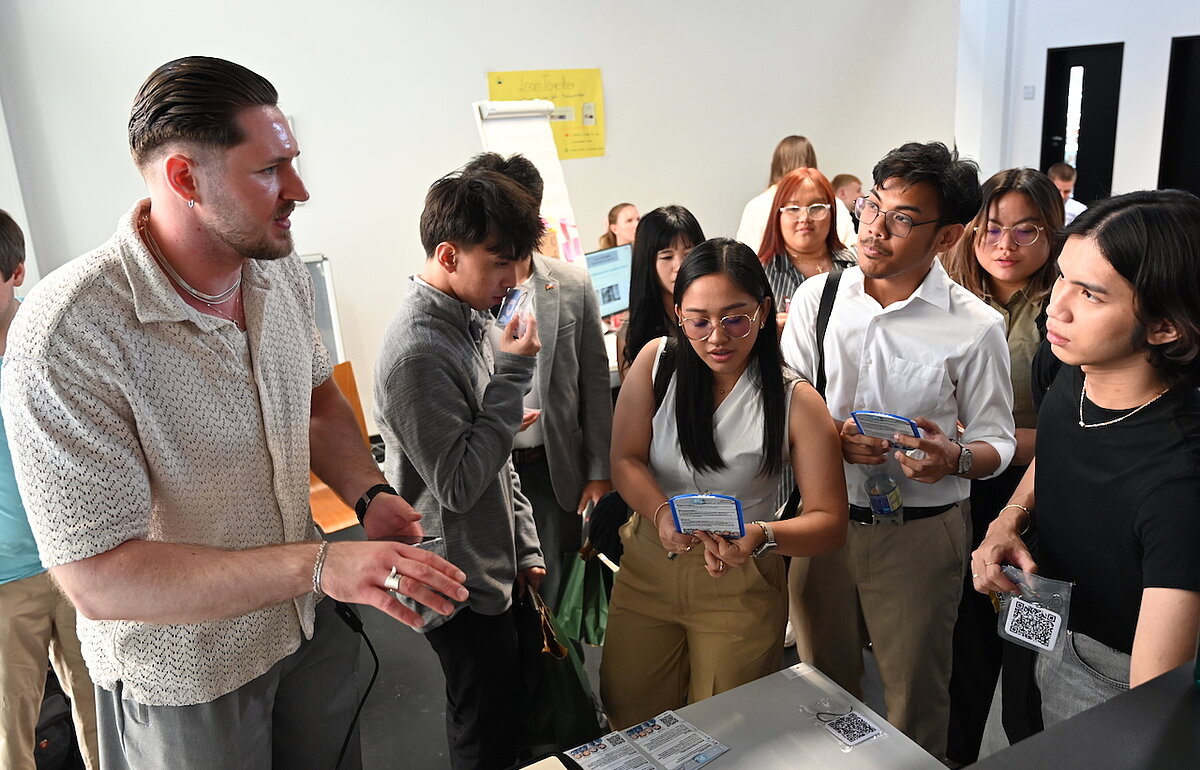 Ein DVM-Studierender stellt sein Projekt zum Parksystem der philippinischen Delegation vor.